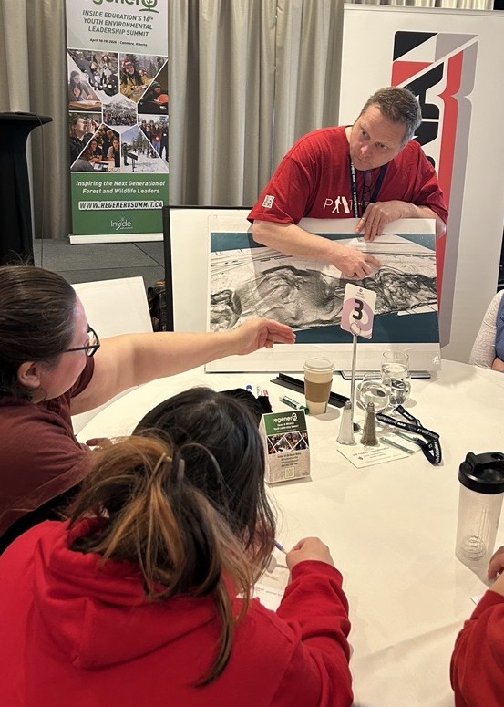 A Pembina team member shares his team's work on landslide mitigation with students 