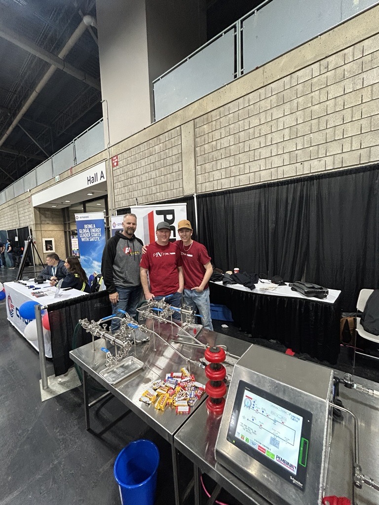 Pembina demonstrates a pigging model to interested students at Skills City